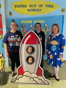 ERS Reading Specialist standing next to a Spaceship