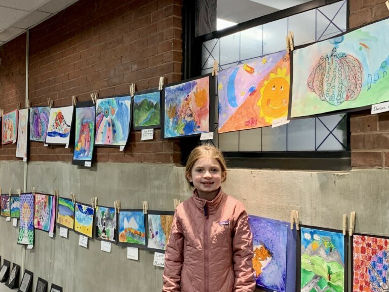 Student in front of Art samples