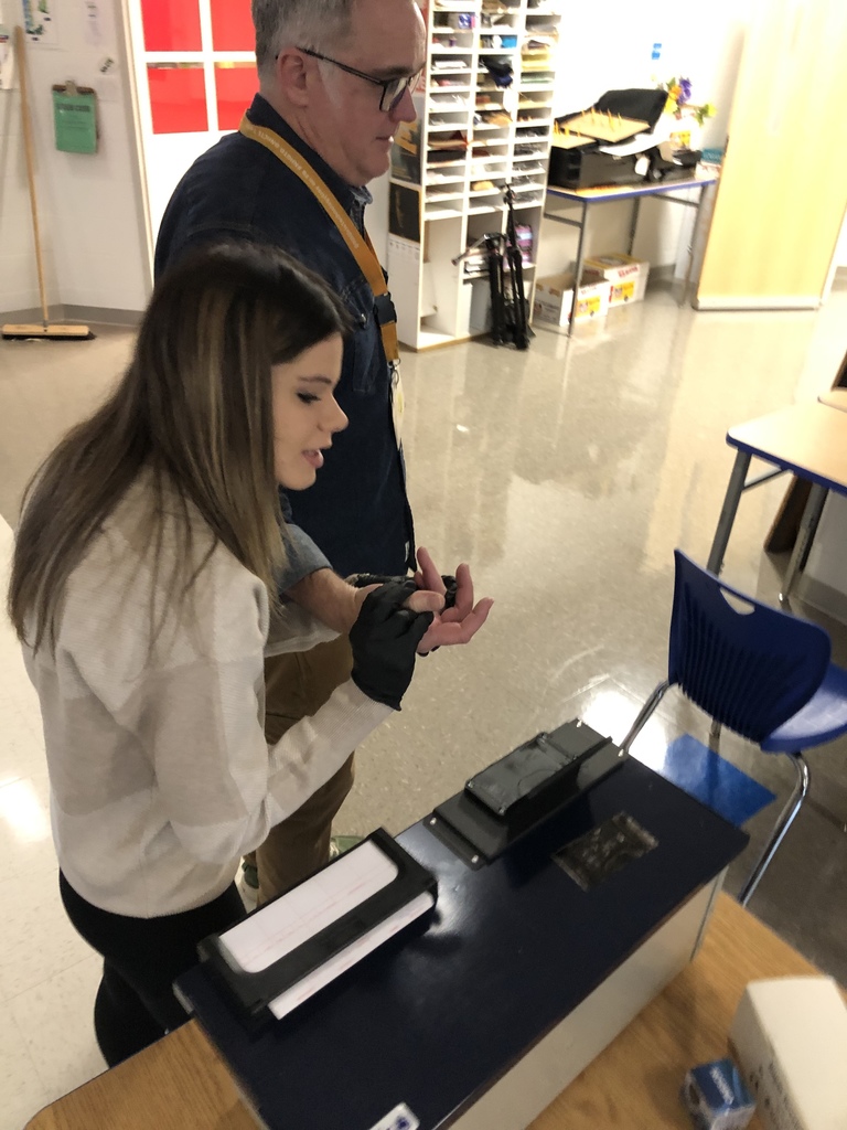 Teacher being fingerprinted by student